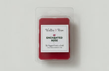 Load image into Gallery viewer, Red wax melt container with 'Enchanted Rose' label on a light gray surface.