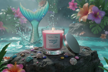 Load image into Gallery viewer, Pink candle labeled 'Mermaid Lagoon' on a rock with a tropical background