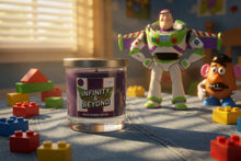 Load image into Gallery viewer, Candle labeled 'Infinity &amp; Beyond' with toy figures in a playful setting
